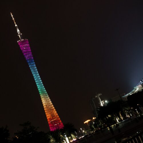 Vibrant night view of the illuminated Canton Tower in Guangzhou against a dark sky.